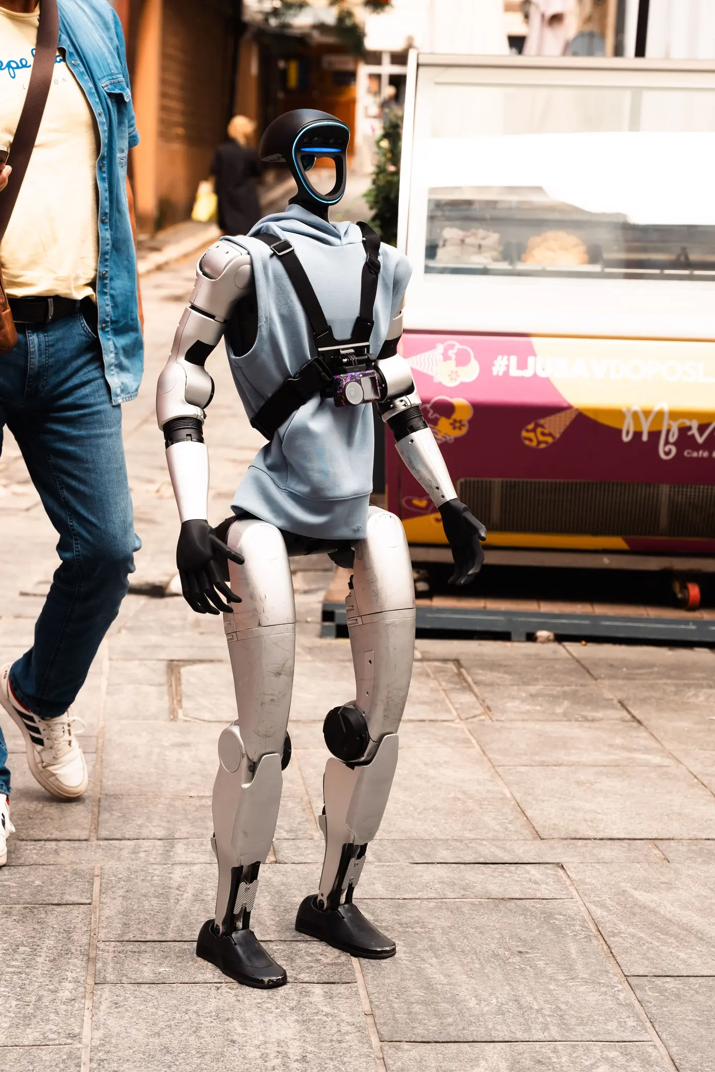 A humanoid robot walking down a busy street